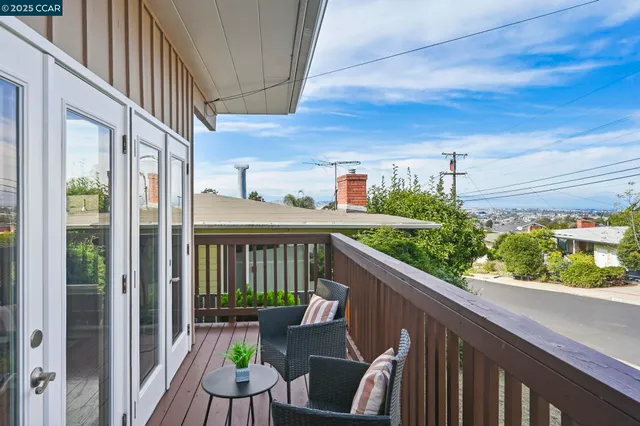 a view of a balcony with furniture