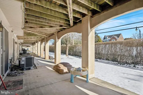 a view of a porch with furniture and front door