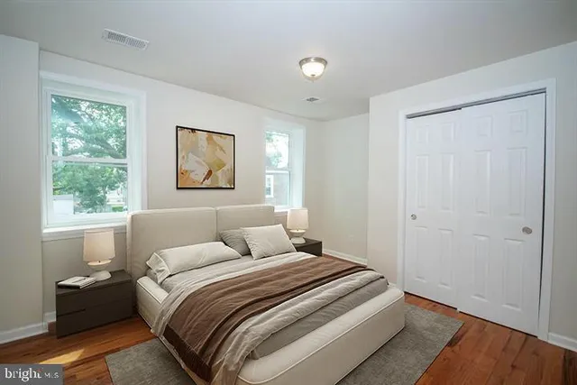 a bedroom with a large bed and a window