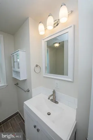 a bathroom with a sink a toilet and mirror