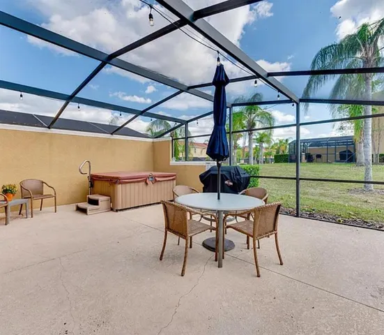 a view of a patio with a table chairs and a backyard