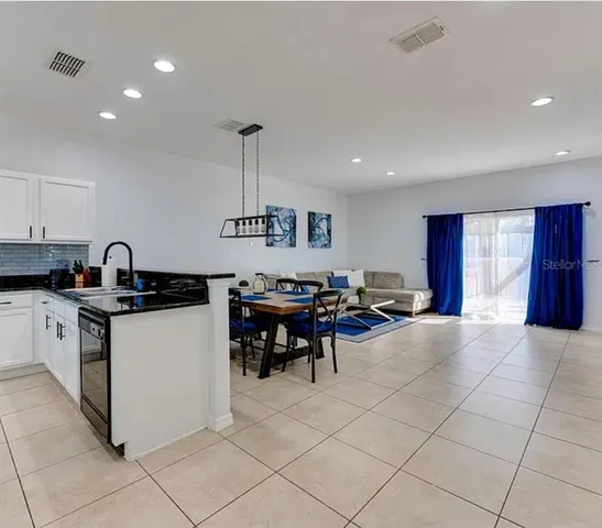 a kitchen with stainless steel appliances granite countertop a sink and cabinets