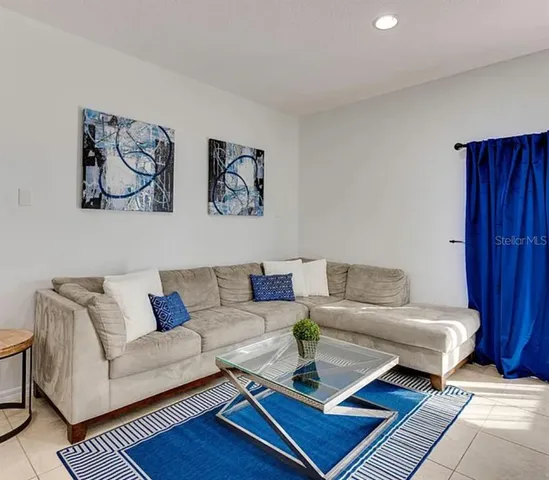 a living room with furniture and a rug