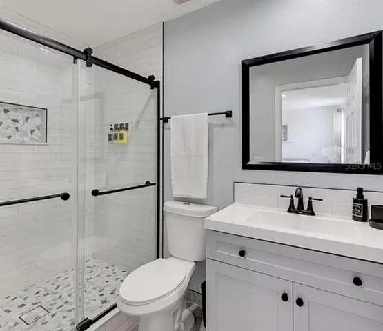 a white toilet sitting next to a bathroom sink