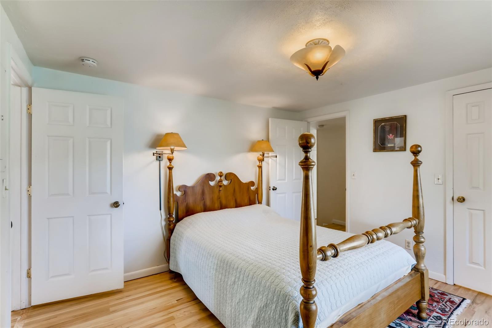 1521 Marshall Road Boulder, CO 80305 - Photo 15 of 40 a bedroom with a bed and a chandelier