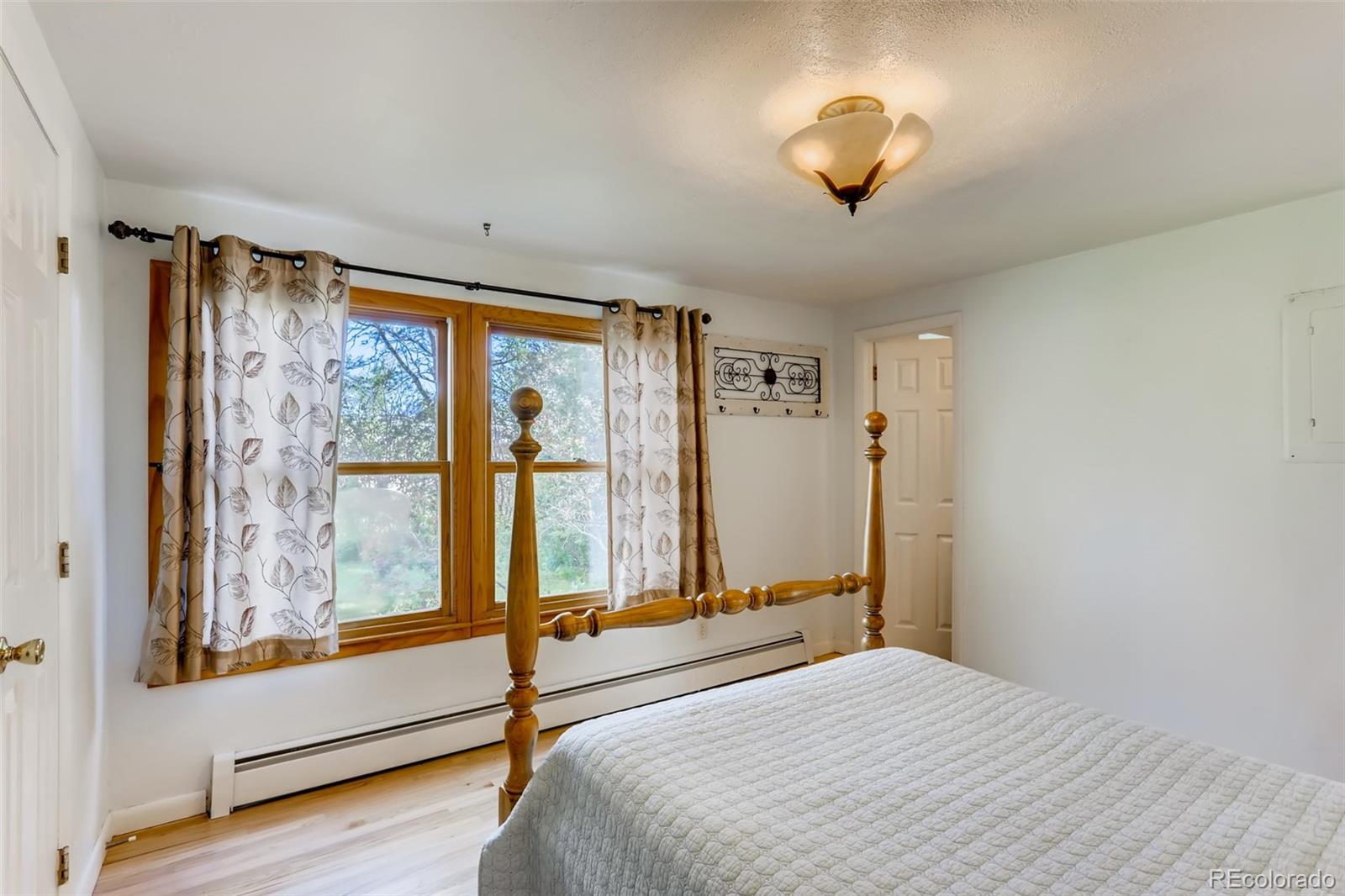 1521 Marshall Road Boulder, CO 80305 - Photo 16 of 40 a bedroom with a large bed and a window