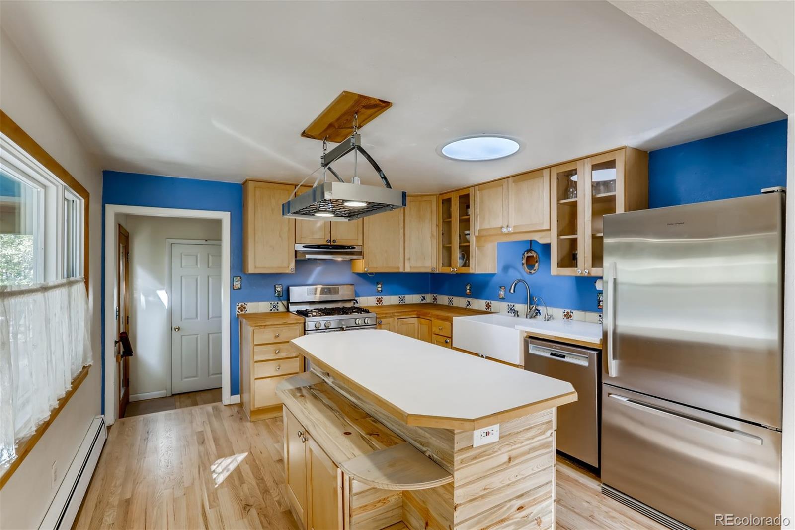 1521 Marshall Road Boulder, CO 80305 - Photo 9 of 40 a kitchen with a refrigerator a sink and cabinets