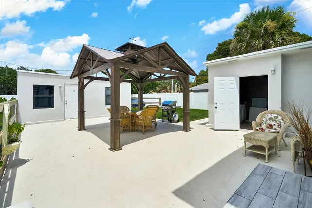 a view of an outdoor dining space with a table and chairs