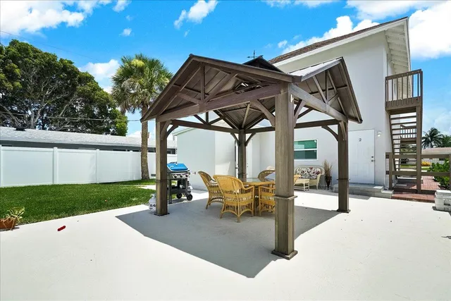 a view of a patio with table and chairs and potted plants