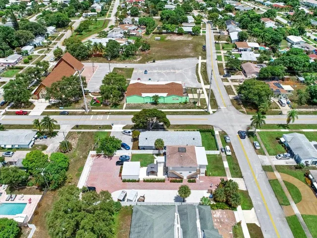 an aerial view of residential houses with outdoor space and swimming pool