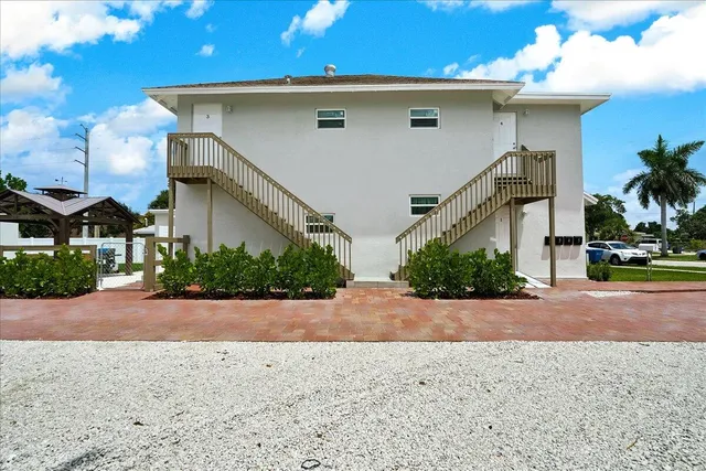 a front view of a house with a yard and a garage