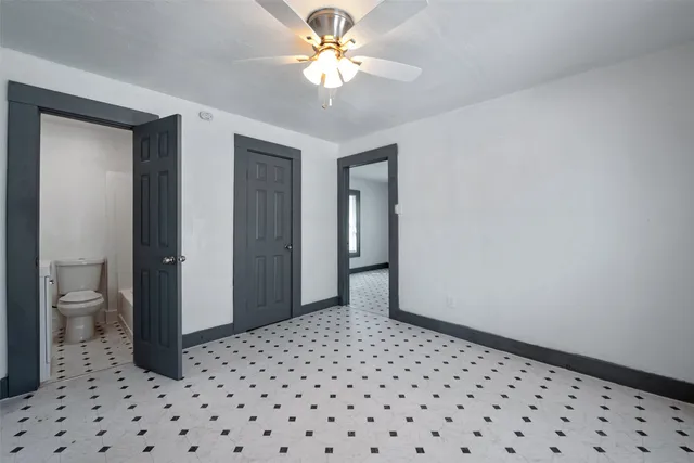 a view of a hallway with a bathroom