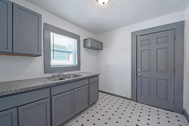a bathroom with a sink a vanity and a window
