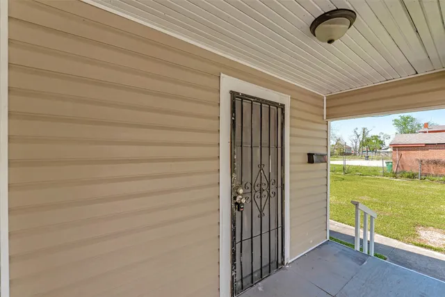 a view of a livingroom with furniture and floor to ceiling window
