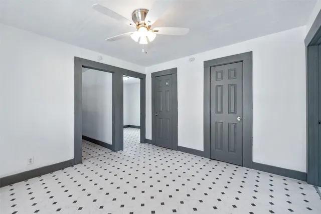 a view of a hallway with a chandelier fan