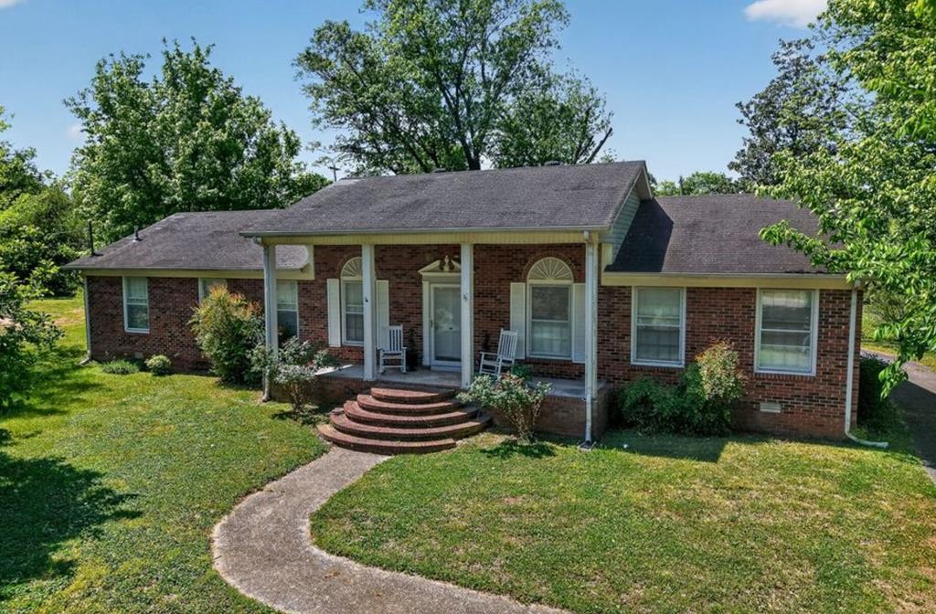 149 North Main Street Sparta, TN 38583 - Photo 1 of 14 a view of a house with a yard potted plants and a table