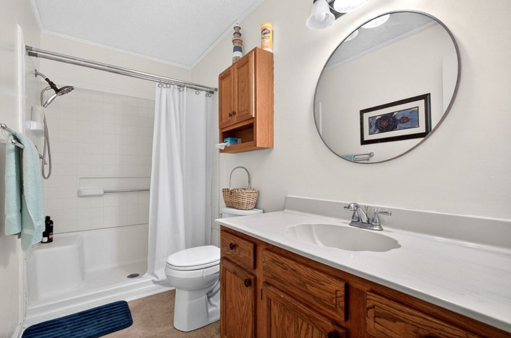 149 North Main Street Sparta, TN 38583 - Photo 11 of 14 a bathroom with a sink a toilet and shower