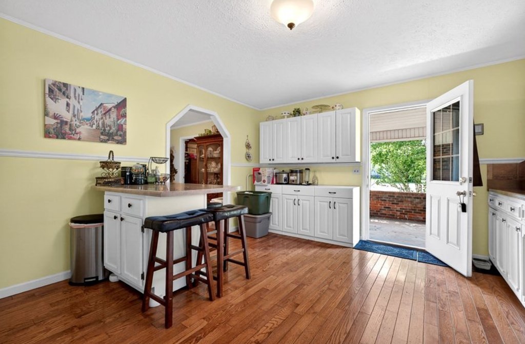 149 North Main Street Sparta, TN 38583 - Photo 6 of 14 a kitchen with stainless steel appliances a stove a sink dishwasher and a refrigerator with wooden floor