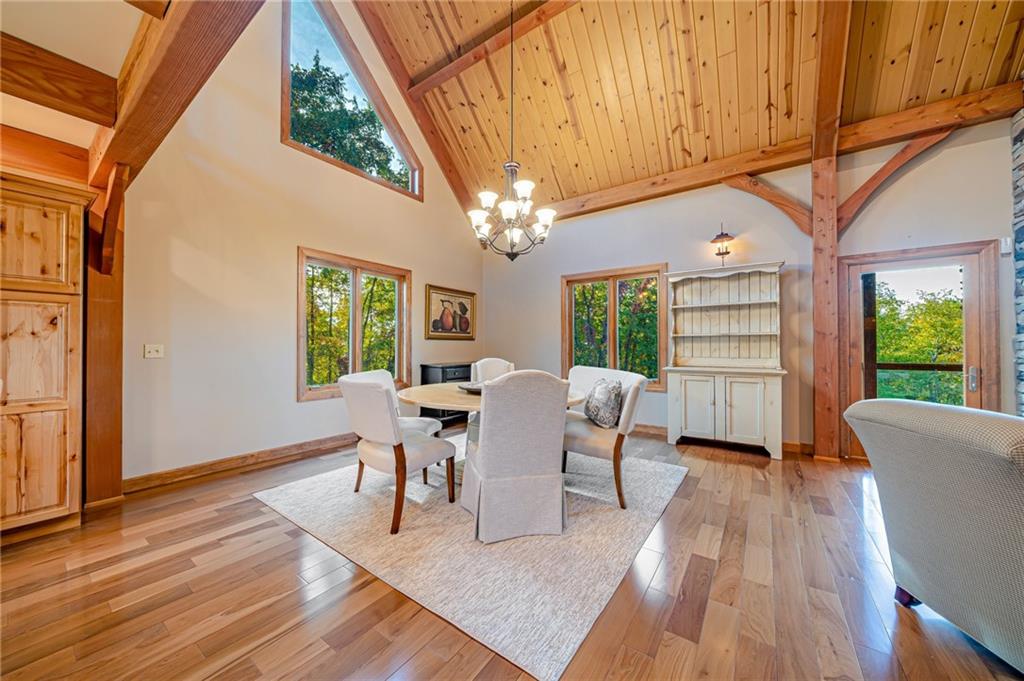 2780 Ipnar Road Irwin, PA 15642 - Photo 12 of 49 a dining room with wooden floor a chandelier a wooden table and chairs