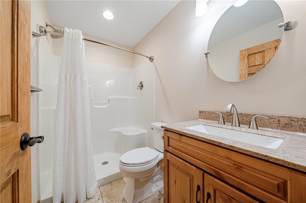2780 Ipnar Road Irwin, PA 15642 - Photo 38 of 49 a bathroom with a granite countertop sink toilet and shower