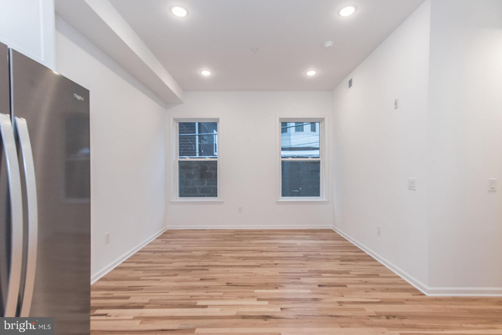 315 North Preston Street, Unit 101 Philadelphia, PA 19104 - Photo 11 of 26 a view of an empty room with wooden floor and a window