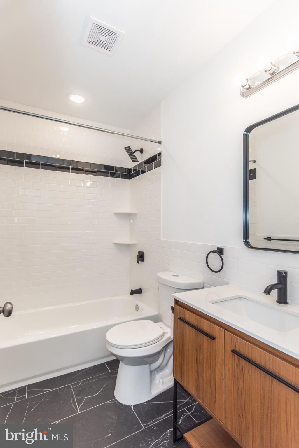 315 North Preston Street, Unit 101 Philadelphia, PA 19104 - Photo 18 of 26 a bathroom with a toilet a sink and a bathtub
