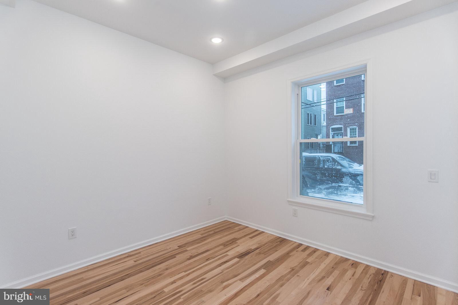 315 North Preston Street, Unit 101 Philadelphia, PA 19104 - Photo 22 of 26 wooden floor in an empty room with a window