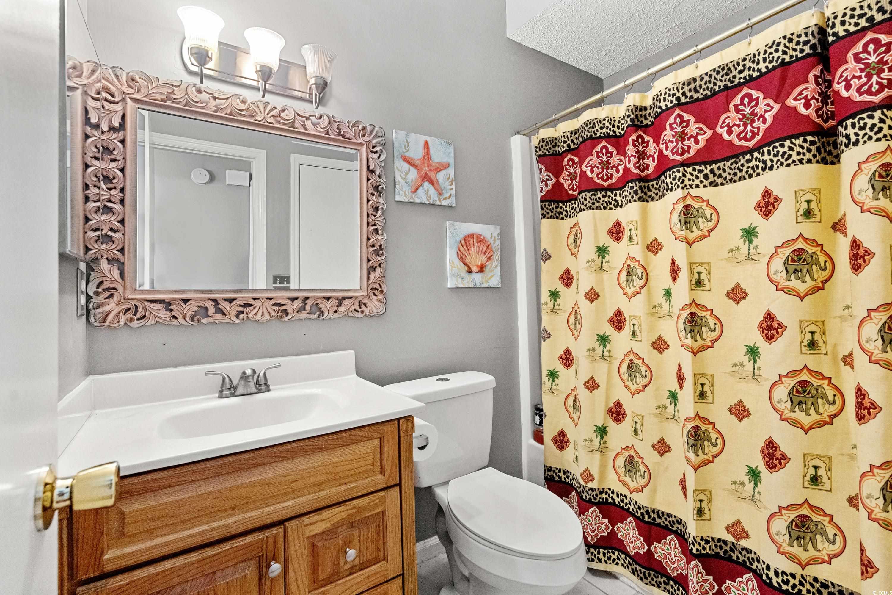 133 Whitehaven Court Myrtle Beach, SC 29577 - Photo 24 of 31 Full bathroom featuring vanity, a textured ceiling
