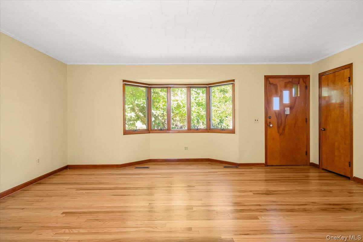 307 Big Island Road Warwick, NY 10921 - Photo 19 of 46 a view of an empty room with wooden floor and a window