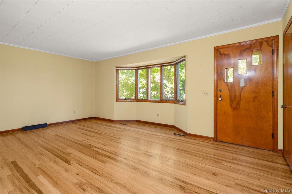 307 Big Island Road Warwick, NY 10921 - Photo 20 of 46 a view of an empty room with wooden floor and a window