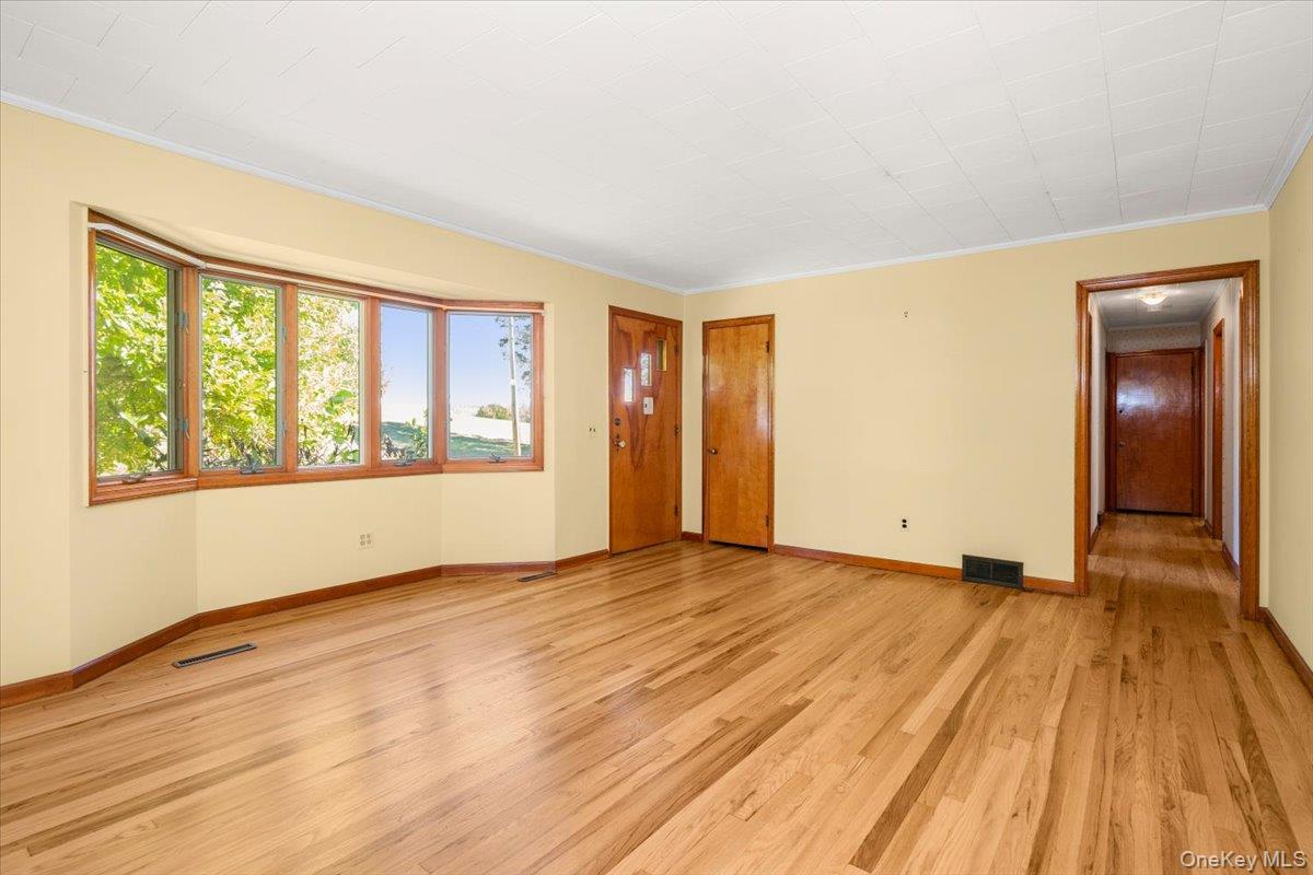 307 Big Island Road Warwick, NY 10921 - Photo 21 of 46 a view of an empty room with wooden floor and a window