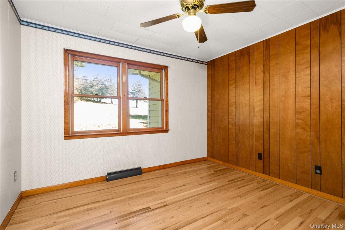 307 Big Island Road Warwick, NY 10921 - Photo 32 of 46 a view of empty room with wooden floor and fan