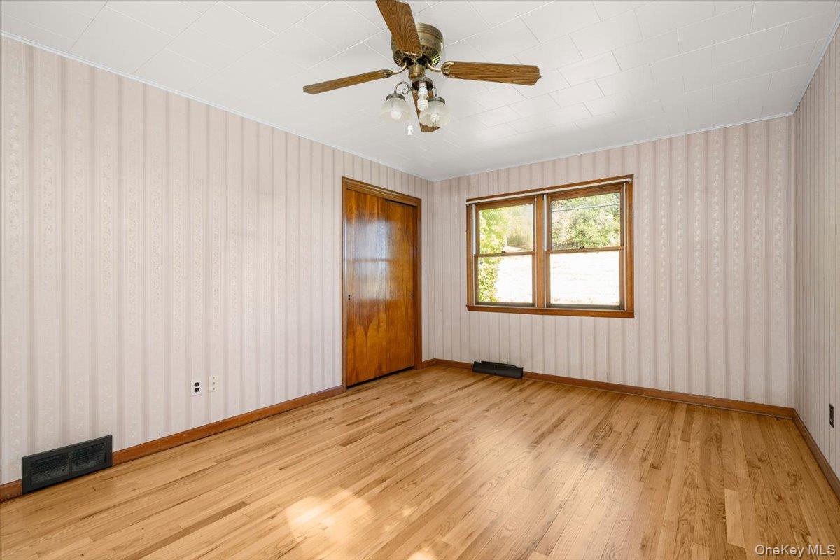 307 Big Island Road Warwick, NY 10921 - Photo 37 of 46 wooden floor in an empty room with a window
