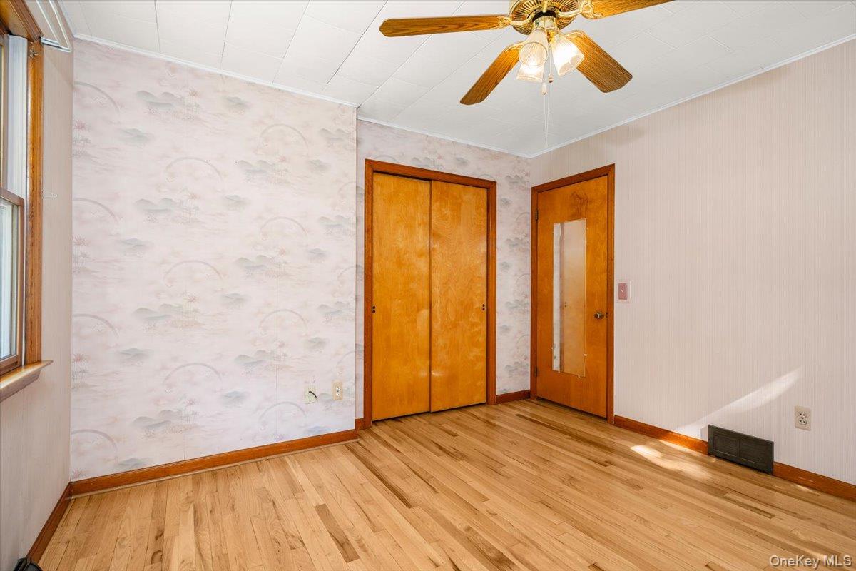 307 Big Island Road Warwick, NY 10921 - Photo 41 of 46 a view of empty room with wooden floor and fan