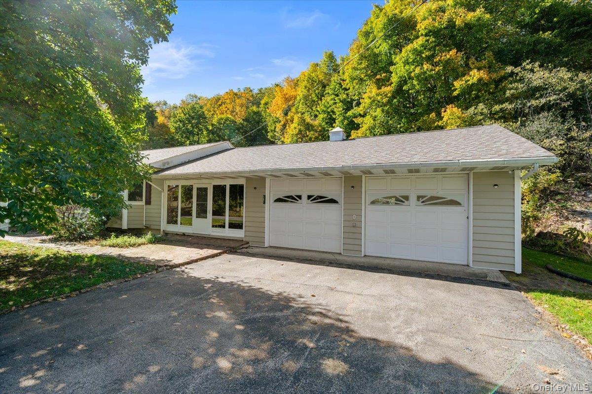 307 Big Island Road Warwick, NY 10921 - Photo 6 of 46 a front view of a house with a yard and garage