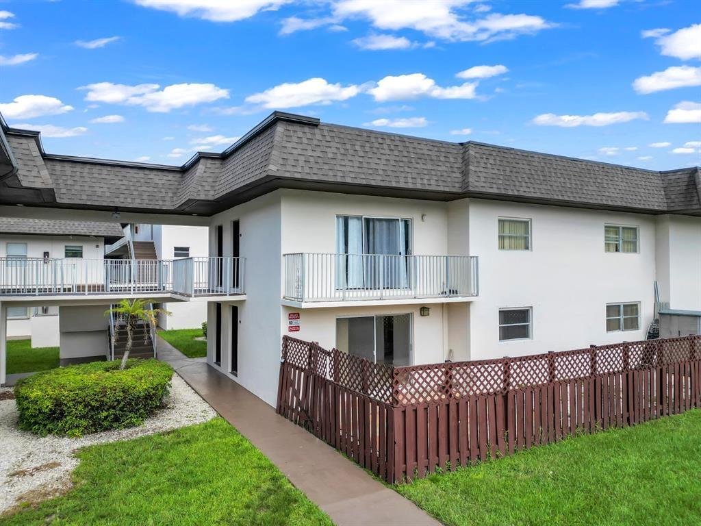 8601 Southwest 94th Street, Unit 201W Miami, FL 33156 - Photo 1 of 14 a view of a house with wooden deck and a garden