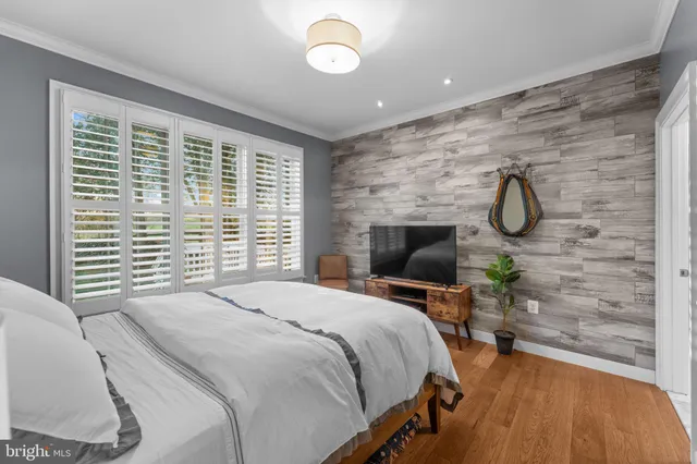 a bedroom with a bed chair and a table