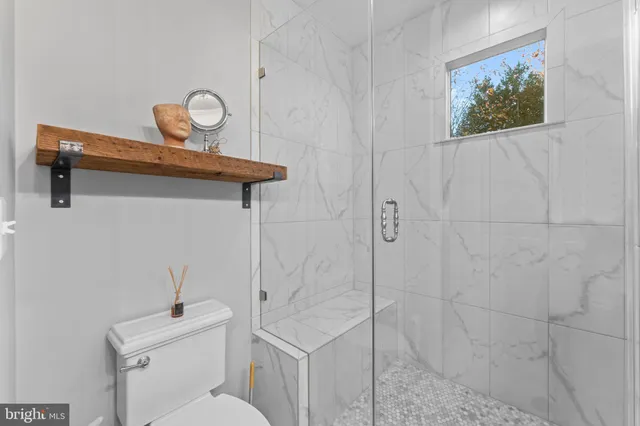 a bathroom with a toilet sink and vanity