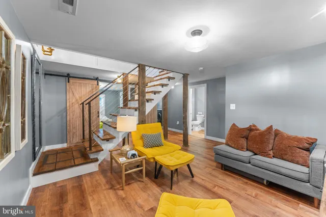 a living room with furniture a rug and a chandelier
