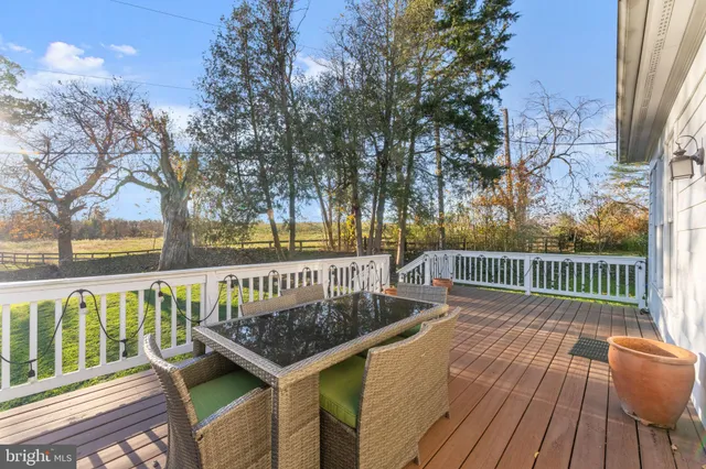 a view of balcony with wooden floor and outdoor seating