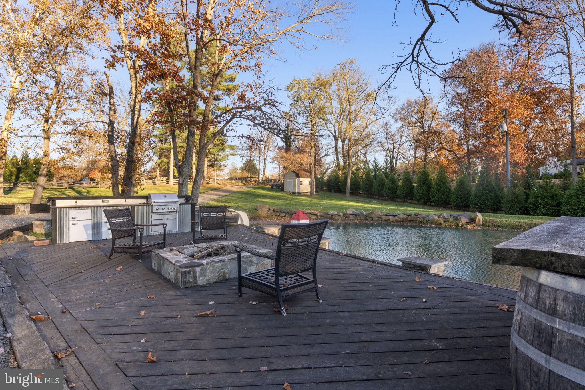 23375 Potts Mill Road Middleburg, VA 20117 - Photo 34 of 48 a view of a lake with tables and chairs
