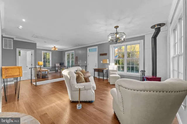 a living room with furniture and a chandelier
