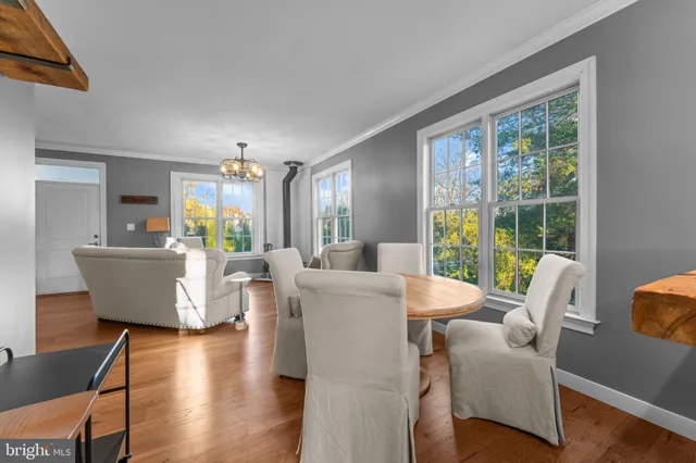 a living room with fireplace furniture and a large window