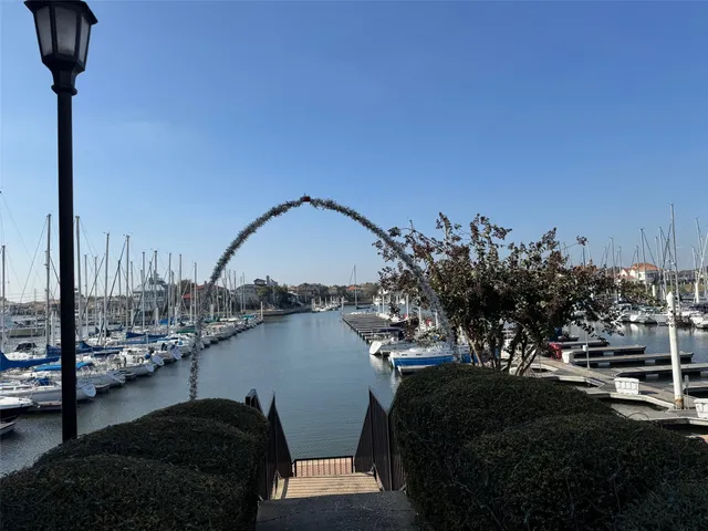 a view of a lake with boats next to a bridge