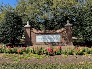 a car parked in front of a brick house