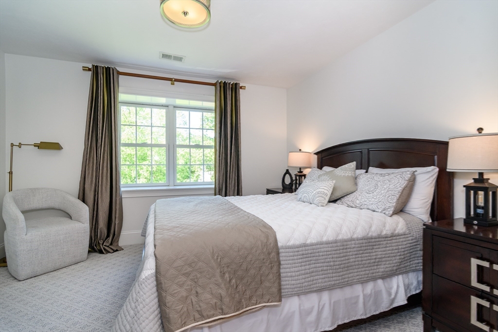 2 Hunters Lane Natick, MA 01760 - Photo 22 of 40 a bedroom with a bed and a lamp