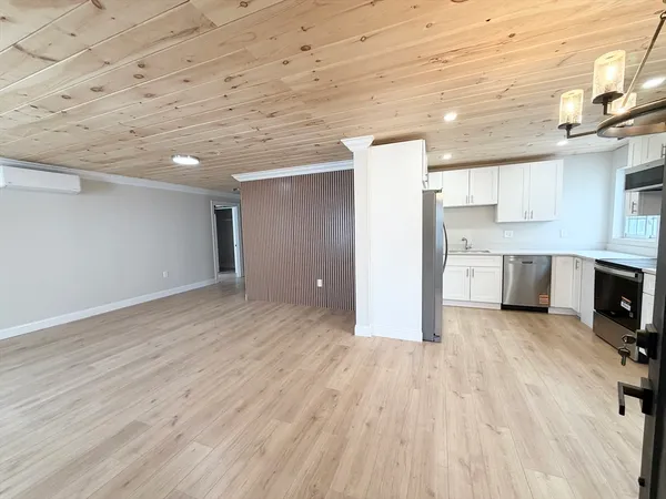 a view of a kitchen with wooden floor