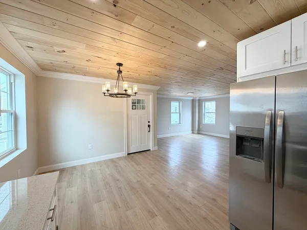 a view of a kitchen with a sink and refrigerator