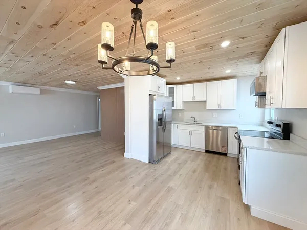a kitchen with stainless steel appliances granite countertop a sink a refrigerator a stove a microwave and cabinets