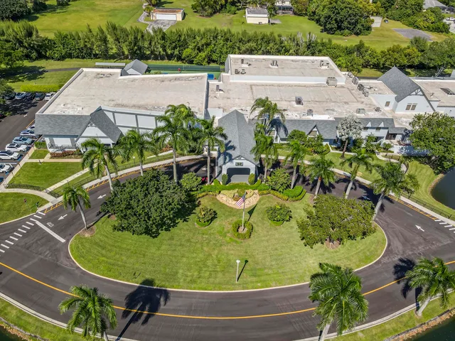 an aerial view of a house with a garden and swimming pool